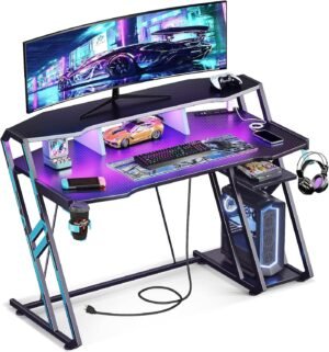 MOTPK Gaming Desk with Power Outlet & LED Lights, Gaming Computer Desk 47inch with PC Storage Shelf, Gaming Table with Carbon Fiber Texture, Gamer Desk, Gift for Boys Men, Black